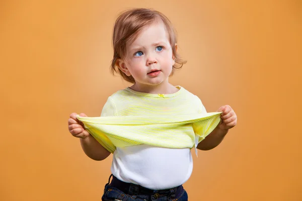 One cute baby girl on orange background — Stock Photo, Image