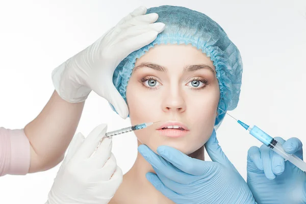 Attractive woman at plastic surgery with syringe in her face — Stock Photo, Image