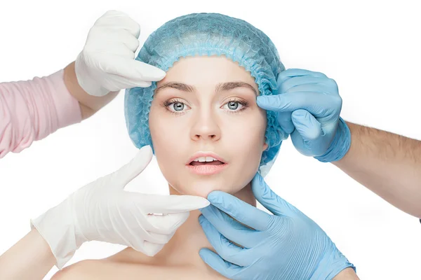 Plastic surgery concept. Doctor hands in gloves touching woman face — Stock Photo, Image