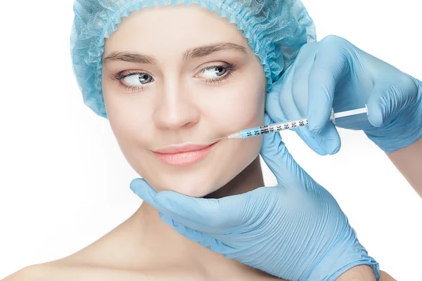 Attractive woman at plastic surgery with syringe in her face — Stock Photo, Image