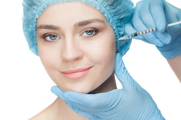 Attractive woman at plastic surgery with syringe in her face — Stock Photo, Image