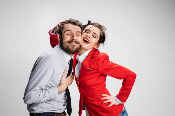 El hombre y la mujer de negocios abrazándose sobre un fondo gris —  Fotos de Stock