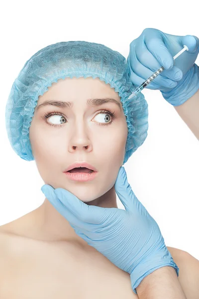 Attractive woman at plastic surgery with syringe in her face — Stock Photo, Image