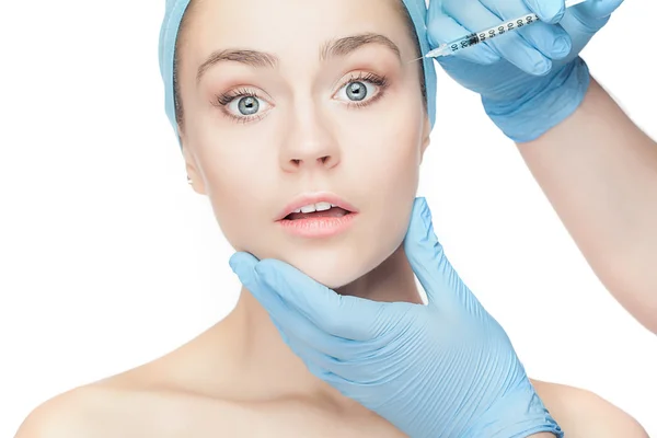 Attractive woman at plastic surgery with syringe in her face — Stock Photo, Image