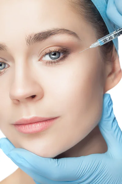 Attractive woman at plastic surgery with syringe in her face — Stock Photo, Image