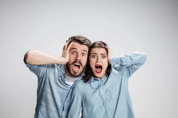 Close up photo of angry man and woman touching their heads — Stock Photo, Image