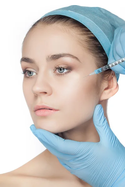Aantrekkelijke vrouw op plastische chirurgie met spuit in haar gezicht — Stockfoto