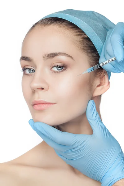 Attractive woman at plastic surgery with syringe in her face — Stock Photo, Image