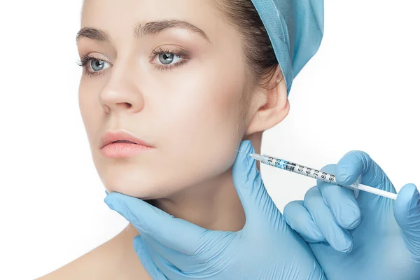 Attractive woman at plastic surgery with syringe in her face — Stock Photo, Image