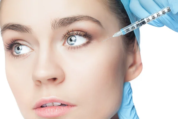 Attractive woman at plastic surgery with syringe in her face — Stock Photo, Image