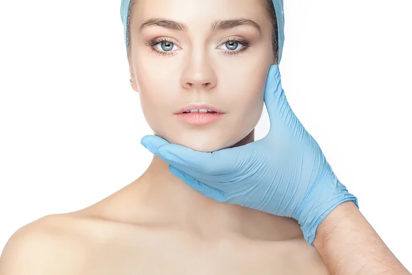 Plastic surgery concept. Doctor hands in gloves touching woman face — Stock Photo, Image