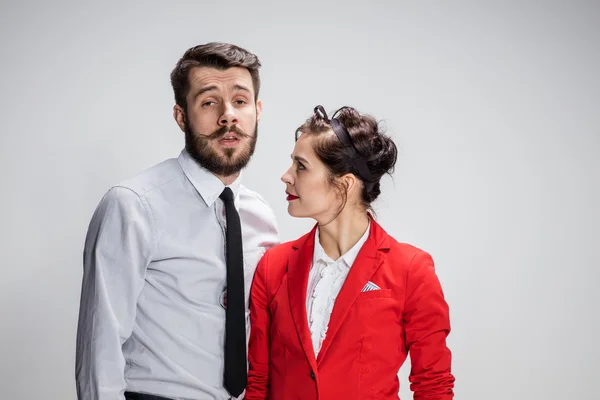 The business man and woman communicating on a gray background — Stock Photo, Image