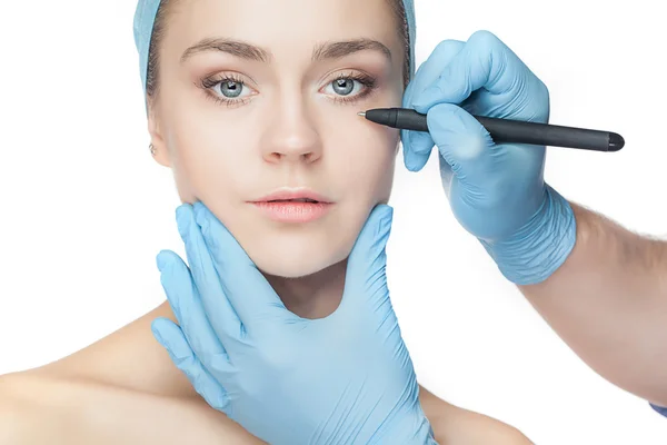 Beautiful young woman with perforation lines on her face before plastic surgery operation. — Stock Photo, Image