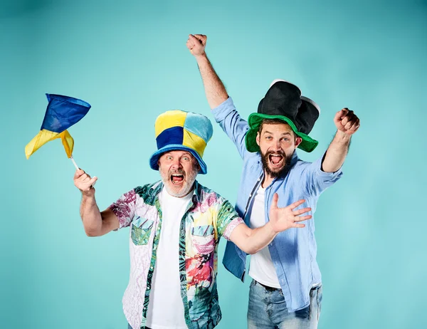 The two football fans with a flag of Ukraine over blue — Stock Photo, Image