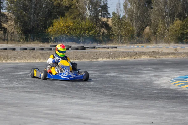 Karting - driver in helmet on kart circuit