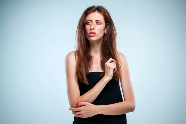 The thoughtful woman on gray background — Stock Photo, Image