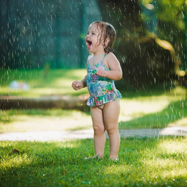 Dziecko dziewczynka bawi się Ogród Kropidło. — Zdjęcie stockowe