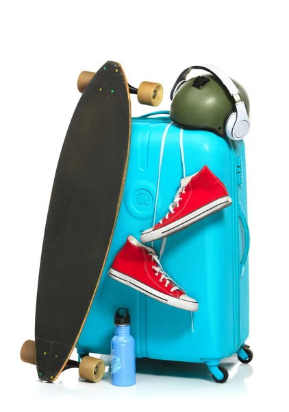 La maleta azul, zapatillas de deporte, monopatín sobre fondo blanco . — Foto de Stock