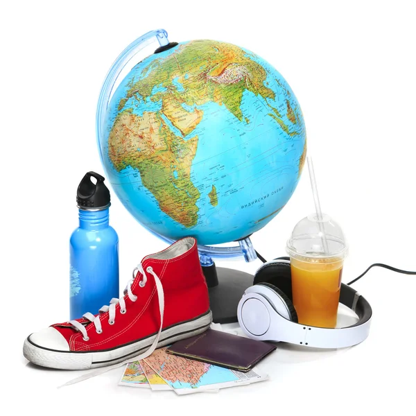 The blue globe, sneakers, thermos and headphones on white background. — Stock Photo, Image