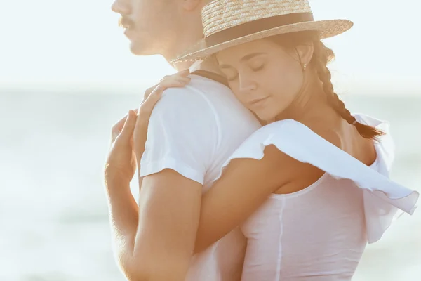 Feliz pareja romántica joven relajándose en la playa y viendo la puesta de sol — Foto de Stock