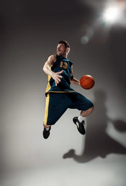 Full length portrait of a basketball player with ball