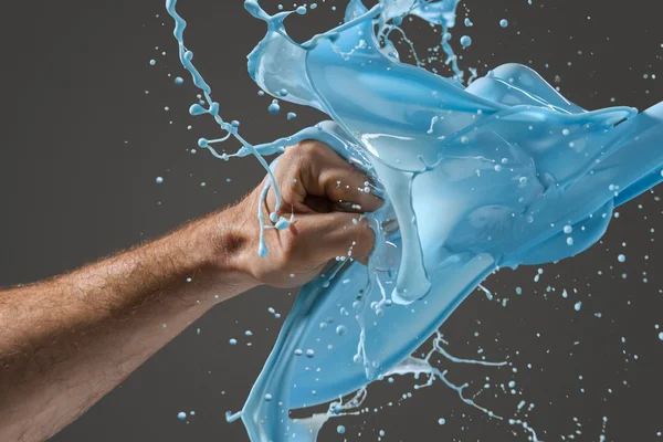 Close-up of a mans fist punching through liquid — Stock Photo, Image