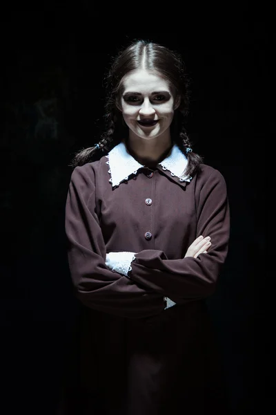 Portrait of a young smiling girl in school uniform as killer woman — Stock Photo, Image