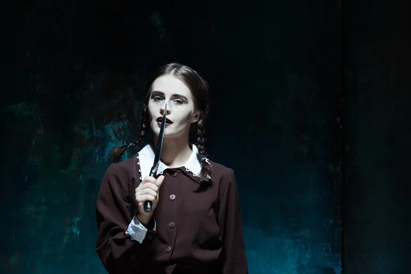 Portrait of a young girl in school uniform as killer woman — Stock Photo, Image