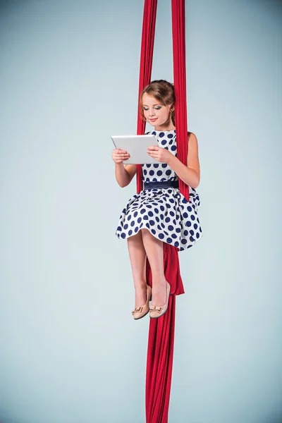 Graceful gymnast sitting with laptop — Stock Photo, Image