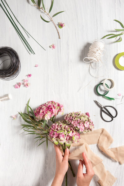 The florist desktop with working tools and ribbons