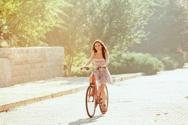 The young girl with bicycle in park — Stock Photo, Image