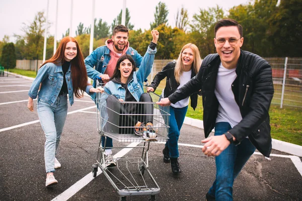 Group of four young diverse friends in jeanse outfit look carefree, young and happy on citys streets