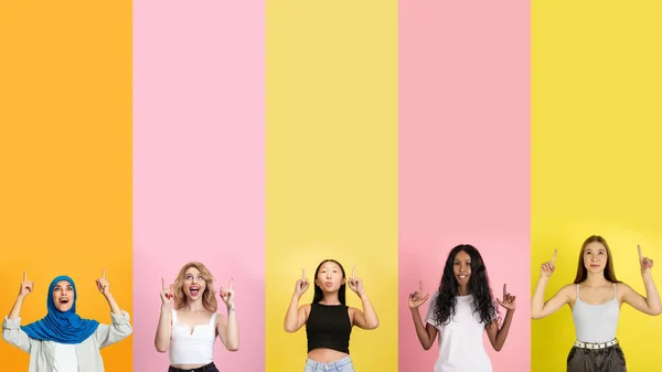Young people pointing up smiling on multicolored background. Human emotions, facial expression concept. Trendy colors. Creative collage. — Stock Photo, Image