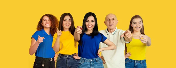 Portrait of young people on bright yellow studio background, collage — Stock Photo, Image
