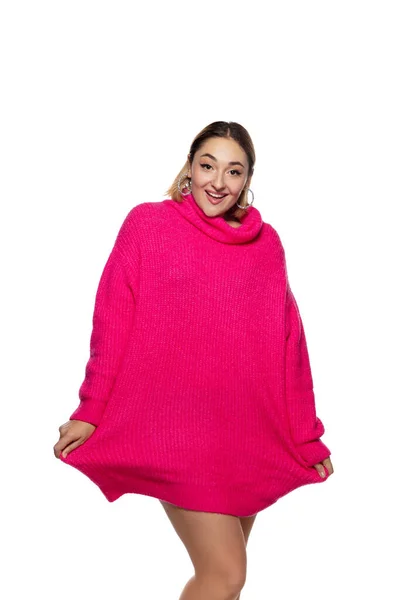 Hermosa mujer joven en suéter cómodo de color rosa brillante, manga larga aislada sobre fondo de estudio blanco — Foto de Stock
