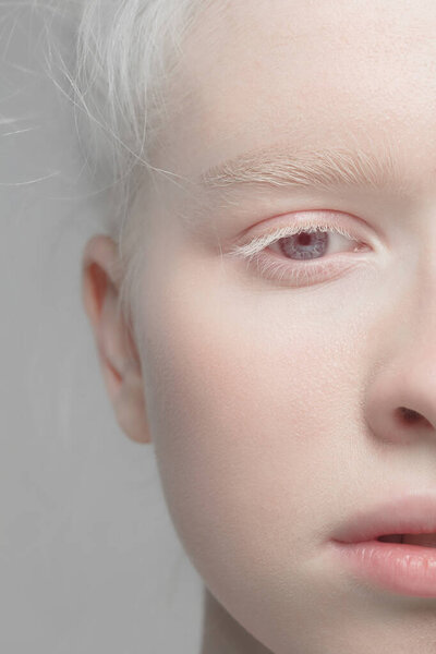 Close up portrait of beautiful albino woman isolated on studio background. Beauty, fashion, skincare, cosmetics concept. Details.