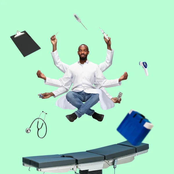 Handsome multi-armed doctor levitating isolated on green studio background with equipment
