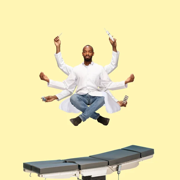Handsome multi-armed doctor levitating isolated on yellow studio background with equipment