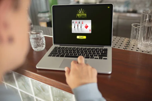 Online gambling, casino concept. Hand near laptop, device with lottery, casino cover