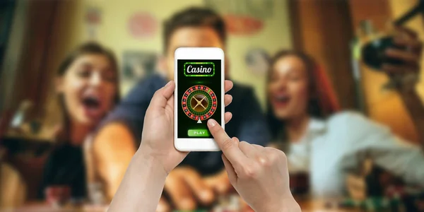 Online gambling, casino concept. Hand holding device with lottery, casino cover