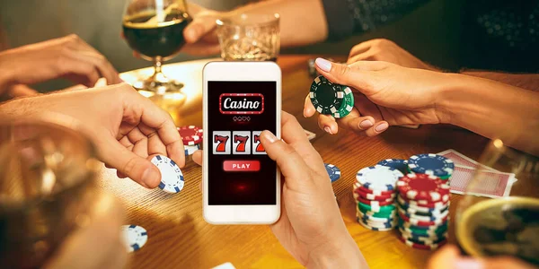Online gambling, casino concept. Hand holding device with lottery, casino cover — Stock Photo, Image