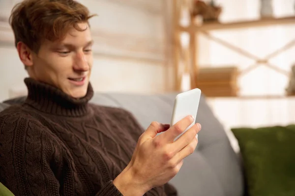 Man reading message, greetings for New Year and Christmas 2021 from friends or family with his cellphone