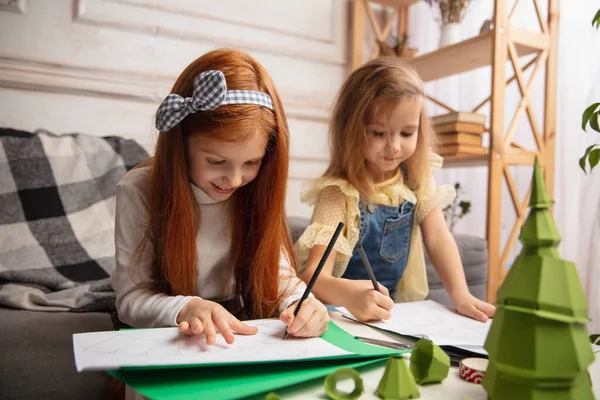 Due bambini piccoli, ragazze insieme in creatività della casa. I bambini felici fanno giocattoli fatti a mano per i giochi o la celebrazione di Capodanno — Foto Stock