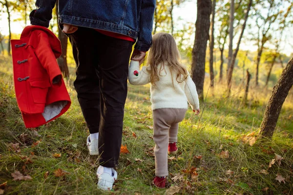 Mutlu baba ve küçük tatlı kız sonbahar güneşli bir günde orman yolunda yürüyorlar. — Stok fotoğraf