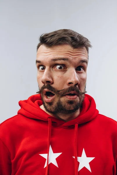 Young man with dual emotions combination on face isolated on white background, emotional and expressive — Stock Photo, Image