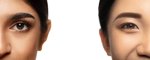 Crop portrait of beautiful caucasian woman and asian female isolated on white studio background. Skincare, cosmetics concept.