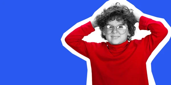 Portrait of young curly boy in red wear on blue studio background. Magazine style concept. — Stock Photo, Image