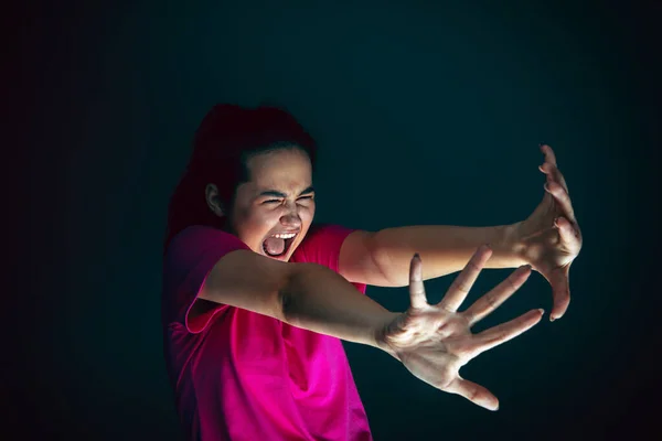 Nahaufnahme Porträt der jungen verrückten verängstigten und schockierten Frau isoliert auf dunklem Hintergrund — Stockfoto