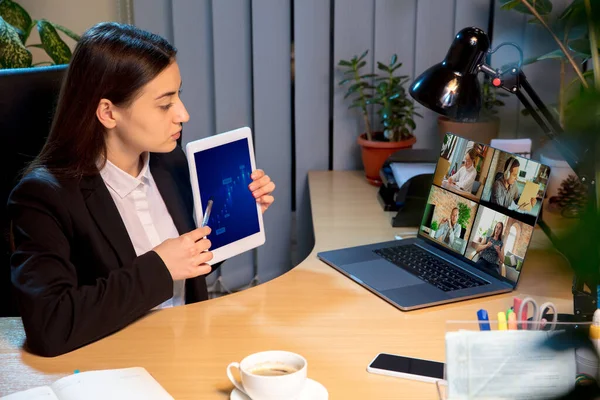 Young woman talking, working during videoconference with colleagues at home — Stock Photo, Image