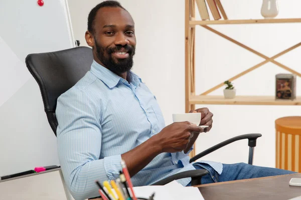 Online english courses at home. Smiling man teaches students remotely in interior of living room